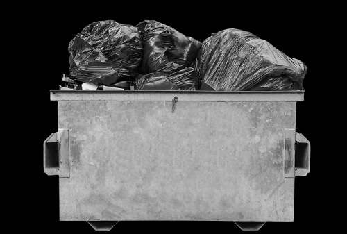 Waste collection vehicle loaded safely under supervision